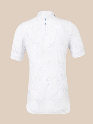 White short-sleeve polo shirt with a light blue geometric line pattern, shown from the back on a solid beige background. The brand name 'CASTORE' is printed vertically in blue on the upper back collar.