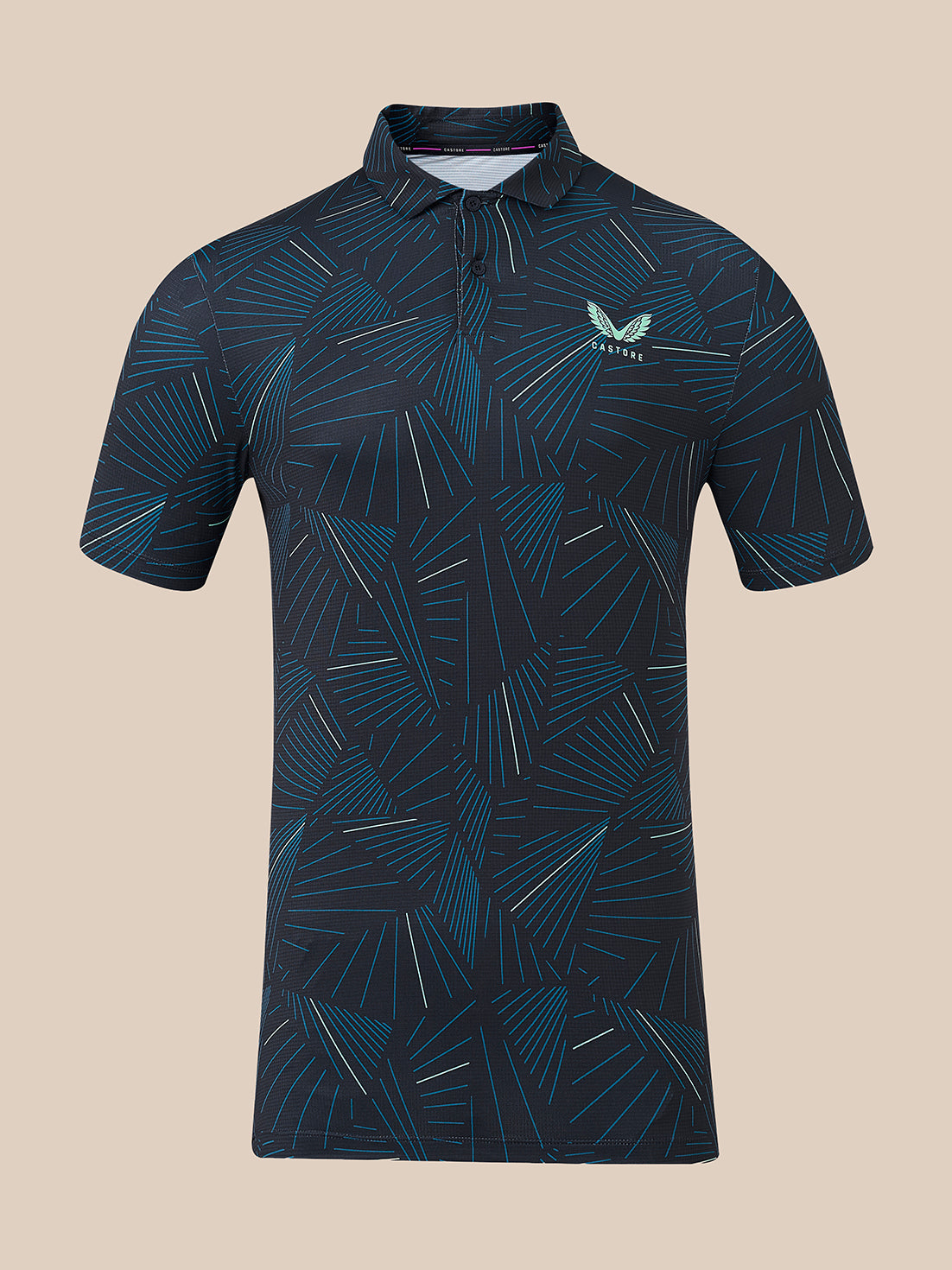 A short-sleeve polo shirt with a dark navy blue base and an all-over geometric pattern in teal and light blue. It features a small white wing logo on the left chest with the brand name 'CASTORE' printed below it.
