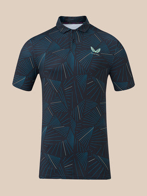 A short-sleeve polo shirt with a dark navy blue base and an all-over geometric pattern in teal and light blue. It features a small white wing logo on the left chest with the brand name 'CASTORE' printed below it.