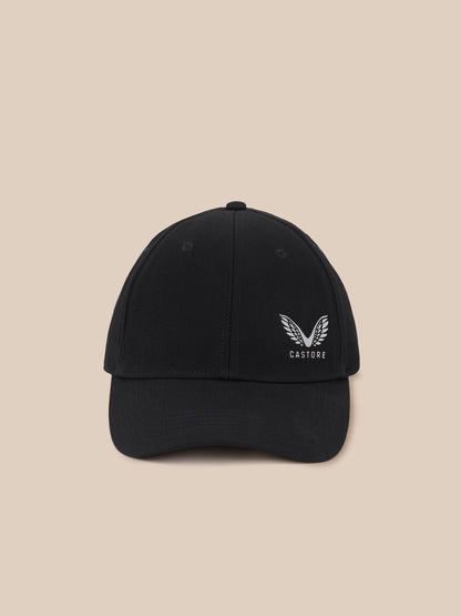 A black baseball cap with a white embroidered wing logo and the word 'CASTORE' on the front, set against a solid beige background.