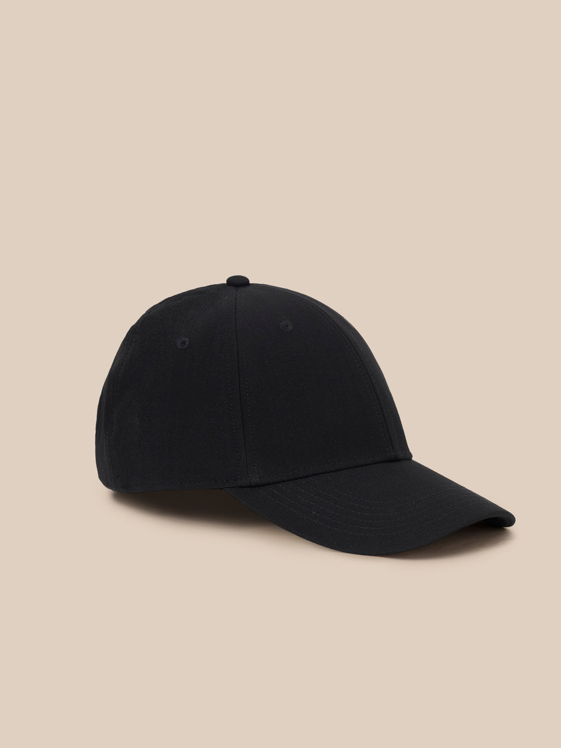 A navy blue baseball cap with a silver and blue shield logo patch on the front, displayed on a clean white background.