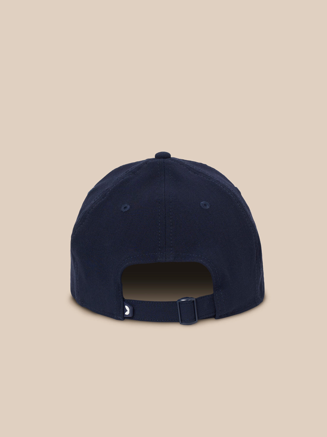 A navy blue baseball cap shown from the back, featuring a curved snapback strap with a small white crescent moon logo, set against a solid beige background.