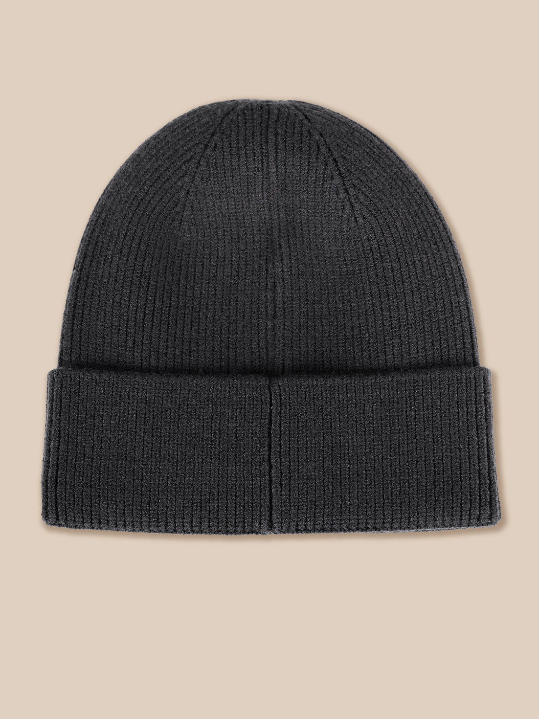 A dark charcoal gray ribbed knit beanie hat with a folded cuff, shown flat against a solid beige background.