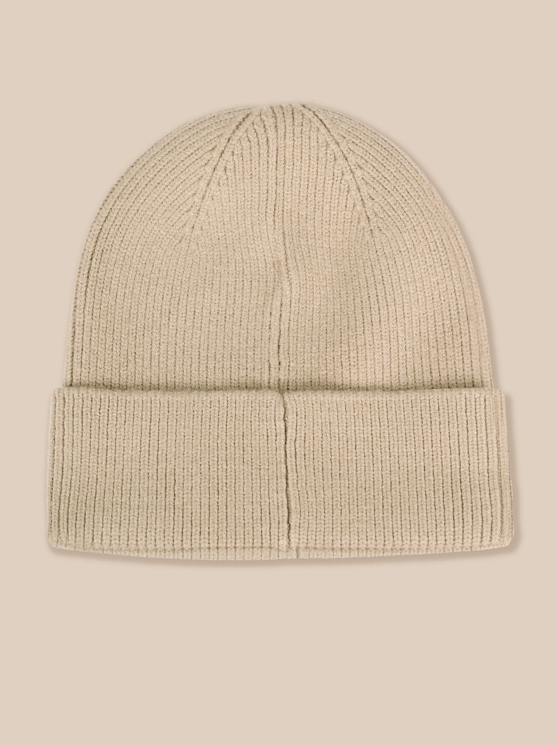 A light beige ribbed knit beanie hat with a folded cuff, shown against a solid light beige background.