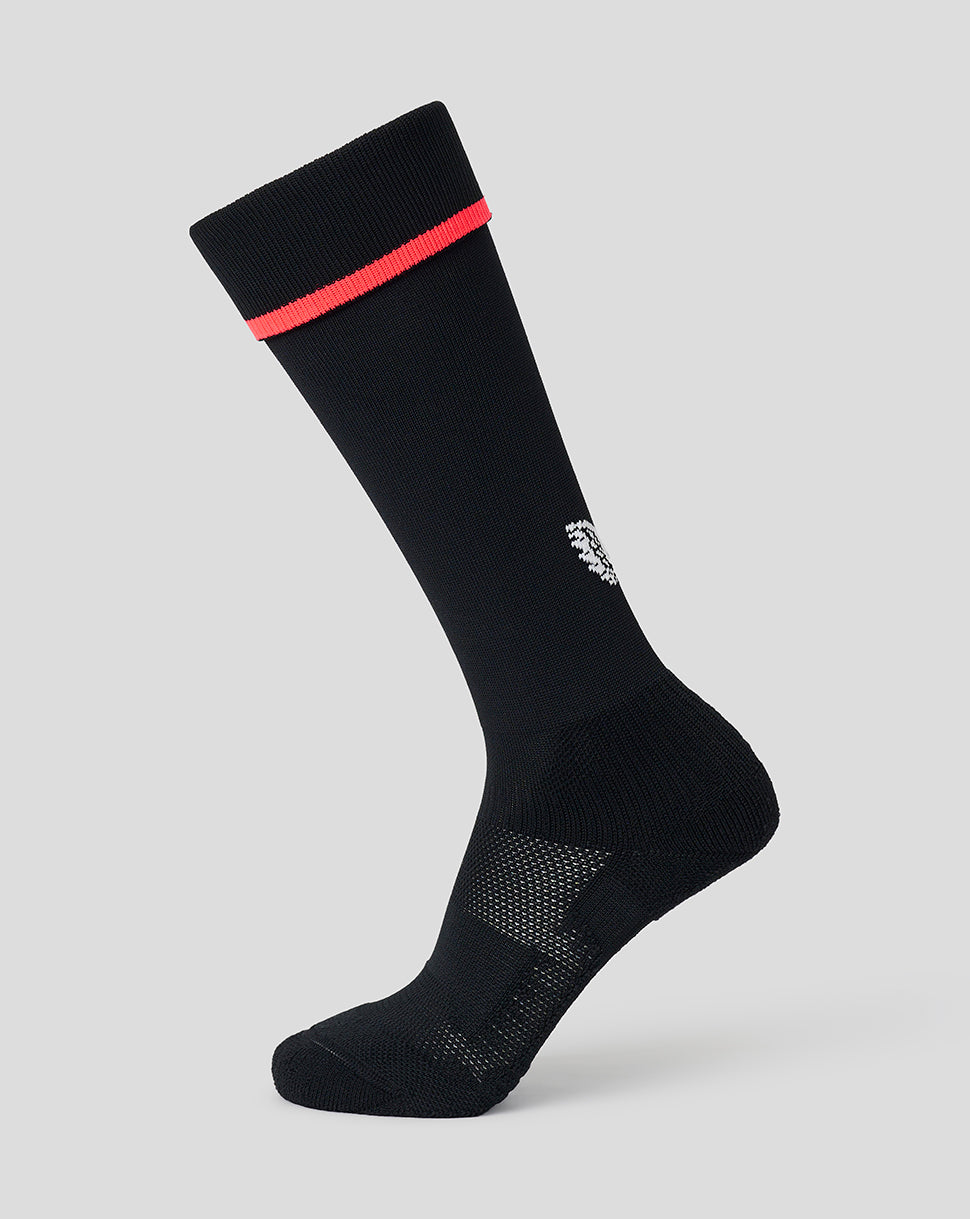 A single black crew sock with a bright red stripe near the cuff and a small white embroidered logo, shown on a light gray background.