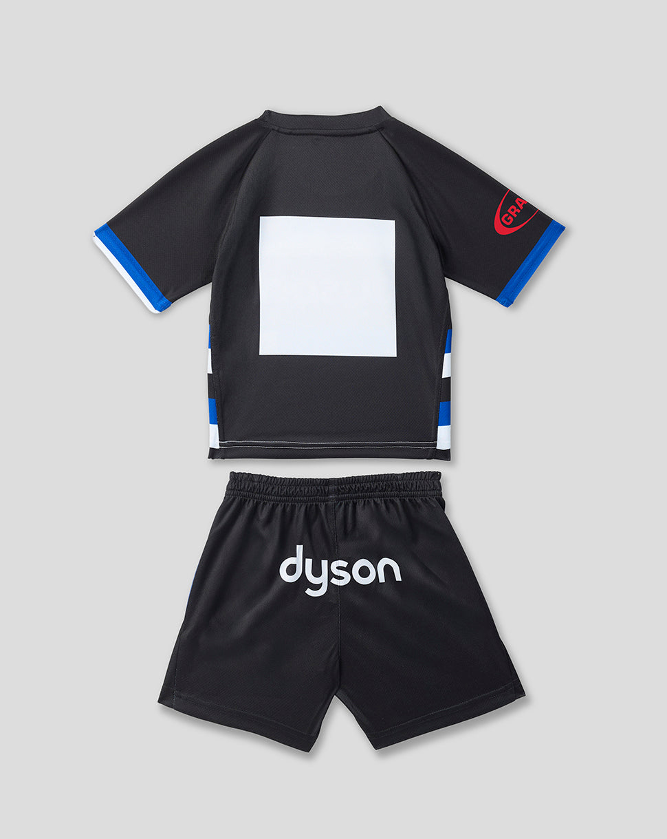 A two-piece kids' athletic set consisting of a black short-sleeve jersey with blue and white sleeve and side accents, and matching black shorts with 'dyson' printed in white on the front, shown on a light gray background.