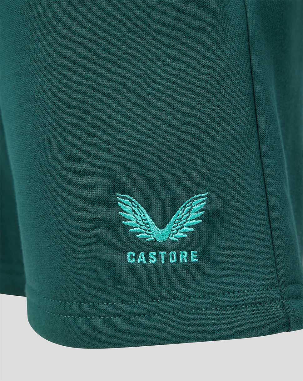Side view of teal green shorts with the Castore logo and wings embroidered on the leg.