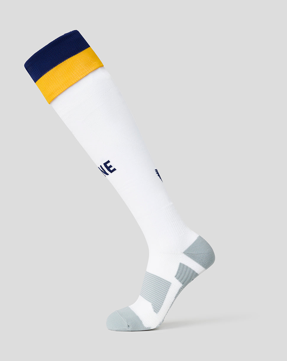 White sock with navy and yellow top on a light gray background