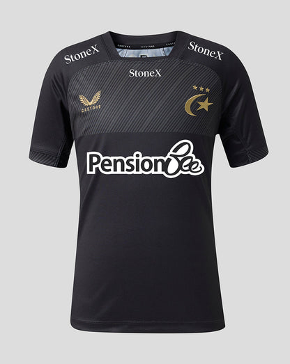 A black short-sleeve sports jersey with a textured dark gray chest panel, featuring the 'Pension Bee' sponsor logo in white across the center, 'StoneX' branding on the shoulders, and a gold winged bird crest with 'Castore' on the right chest, alongside a gold crescent and stars emblem on the left chest, set against a solid light gray background.