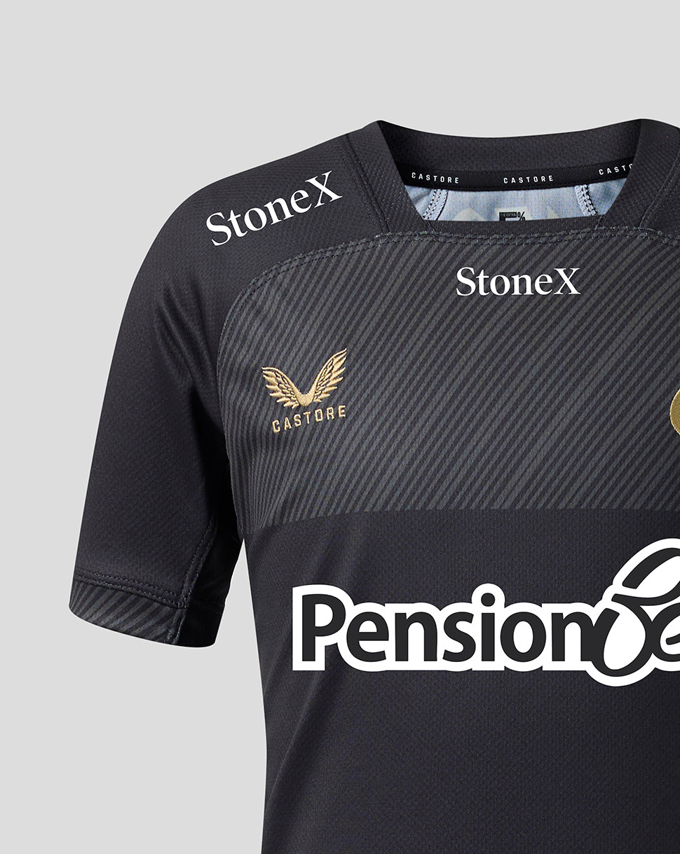 Close-up of a dark gray athletic jersey with diagonal textured stripes, featuring 'StoneX' logos on the shoulders, a gold winged eagle crest with 'CASTORE' on the chest, and a white 'Pension' sponsor logo across the lower front.