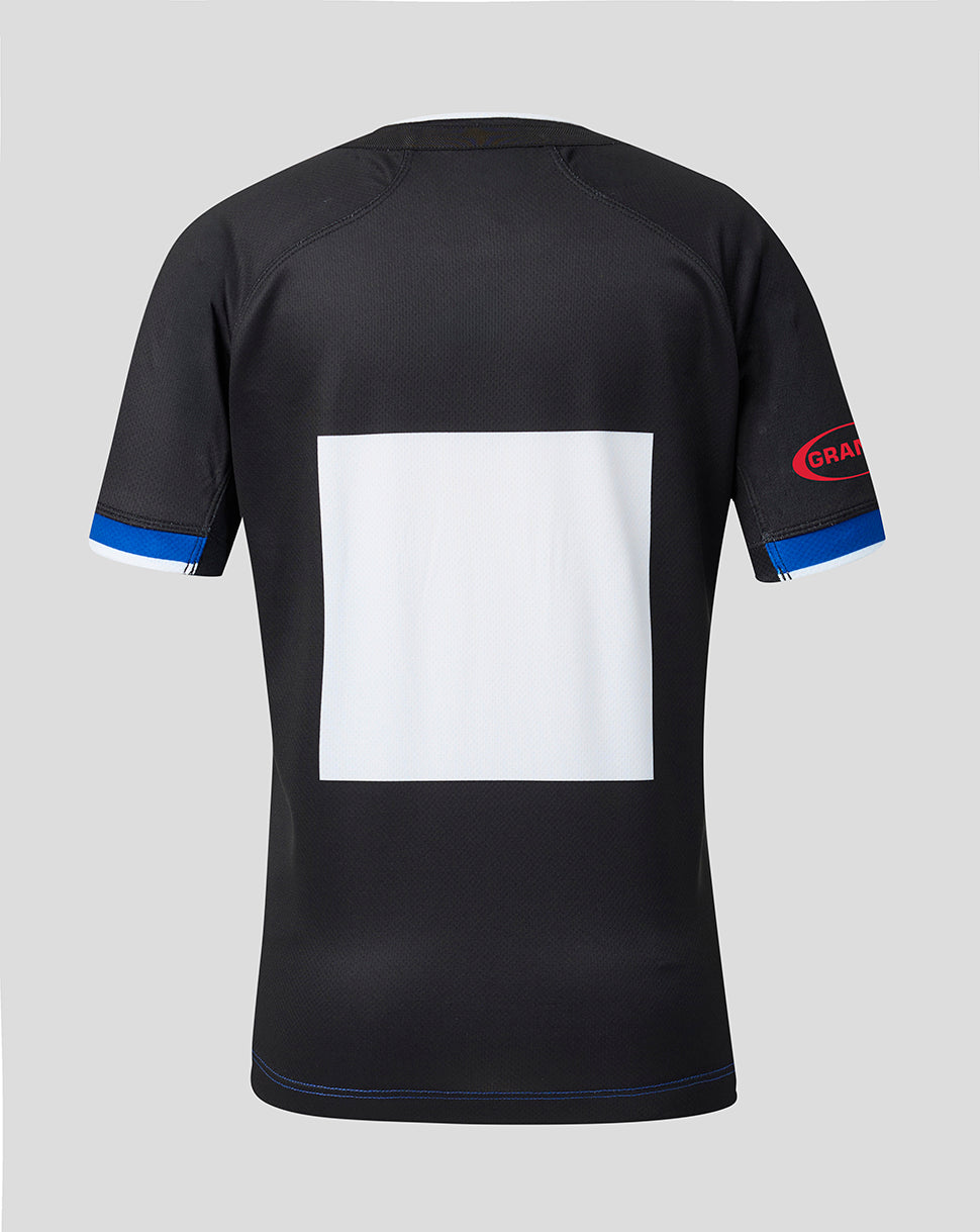 Black short-sleeve athletic jersey shown from the back, featuring a large blank white square on the back, blue trim on the sleeve cuffs, and a red and blue 'GRAM' logo on the right sleeve, set against a solid gray background.
