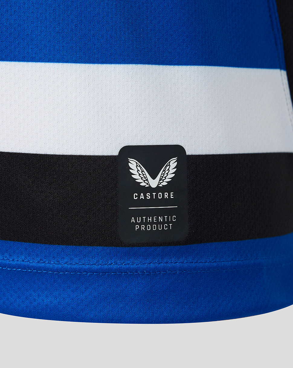 Close-up of a striped athletic garment with blue, white, and black horizontal bands, featuring a black Castore patch on the front.
