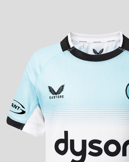 A close-up of a Castore rugby jersey in light blue and white with black trim, featuring the Castore wing logo and a partial Dyson sponsor logo.
