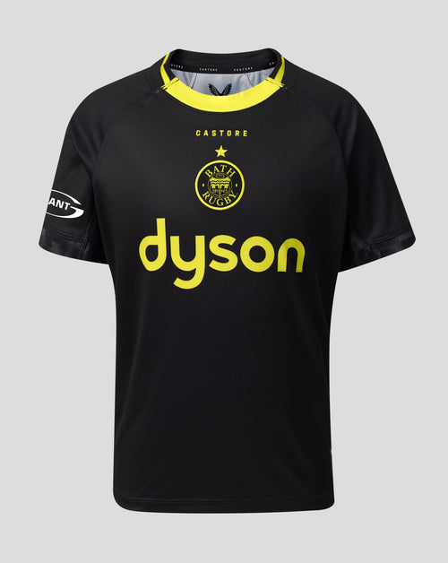 A black Castore jersey with a yellow collar, featuring the yellow Castore logo and a large yellow Dyson sponsor logo on the front, set against a solid gray background.