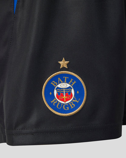 Close-up of a black athletic shorts leg featuring the Bath Rugby club crest embroidered in blue, gold, red, and white, with a gold star above it.