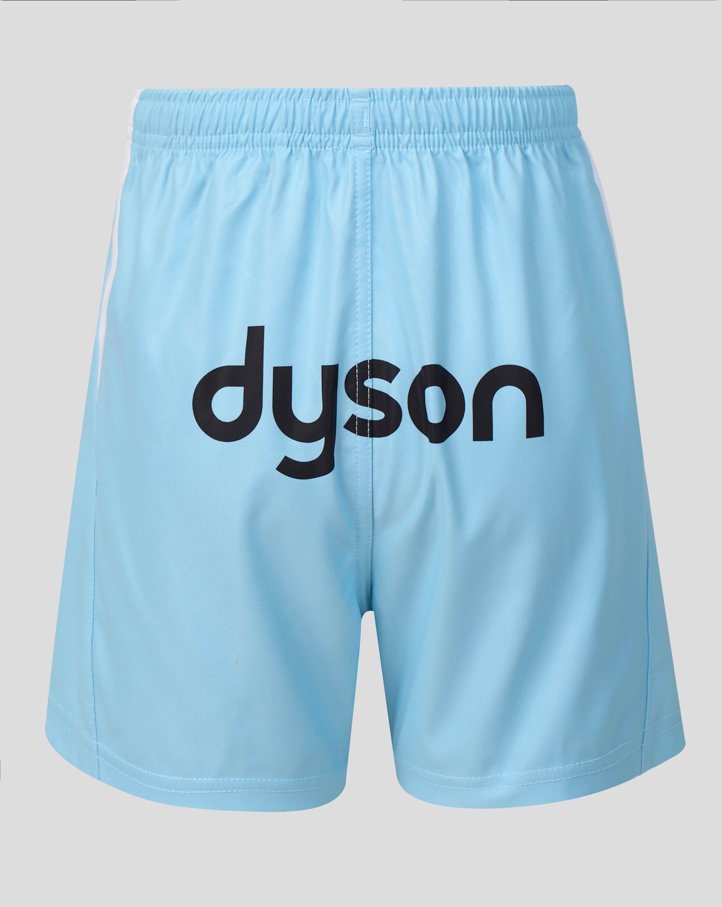 Light blue athletic shorts with a black 'dyson' logo printed across the front, shown against a neutral gray background.