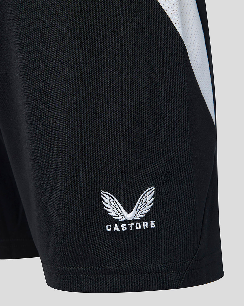 Close up at the lower leg of black Feyenoord Junior shorts with white Castore logo embroidery