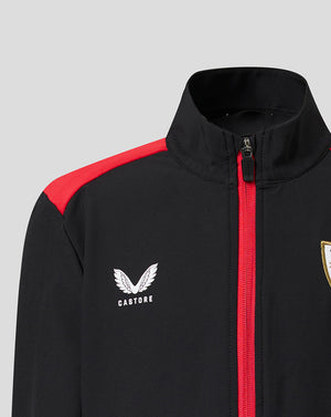 Close-up of Athletic Club jacket showing black fabric red zipper and shoulder stripe with Castore logo and crest.