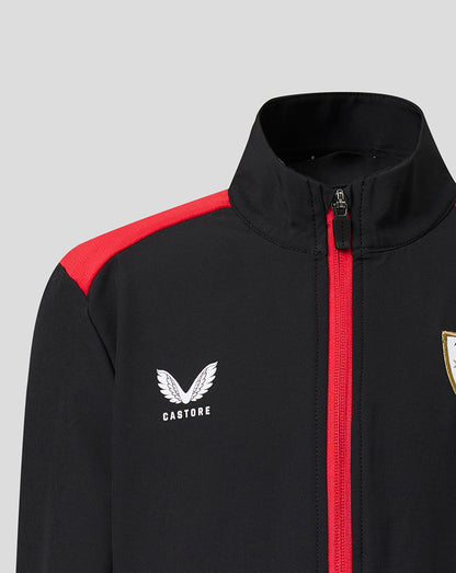 Close-up of Athletic Club jacket showing black fabric red zipper and shoulder stripe with Castore logo and crest.
