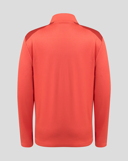 A coral red long-sleeve athletic pullover shown from the back, featuring subtle textured knit fabric and darker red shoulder panels, set against a solid light gray background.