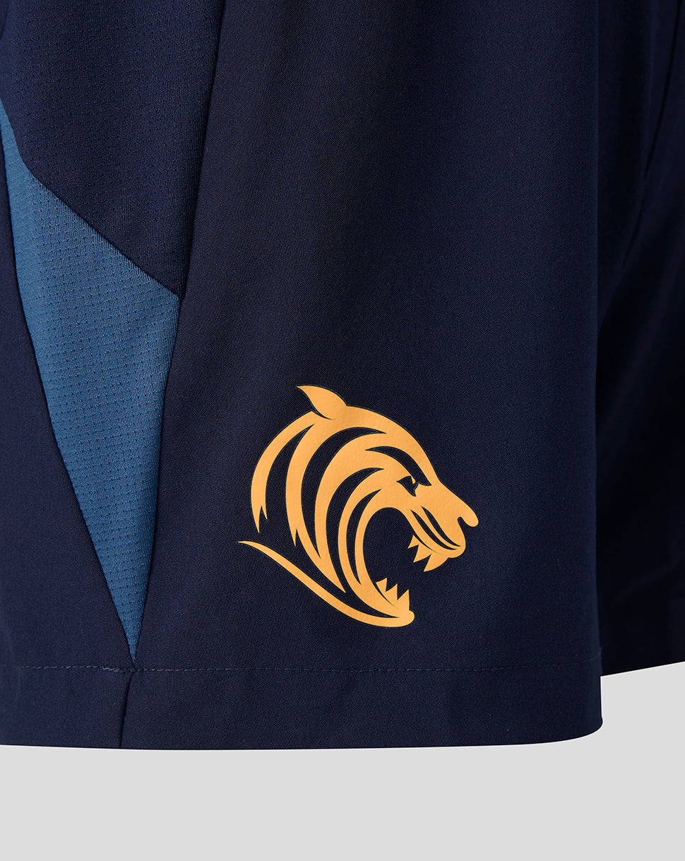Side view of navy training shorts with blue side panels and a gold tiger crest on the lower left leg.
