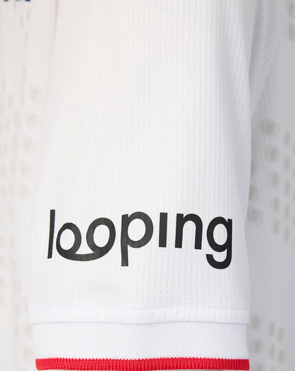 Close-up of the sleeve hem on the FC Twente Third Shirt showing looping branding on white fabric with red edge.