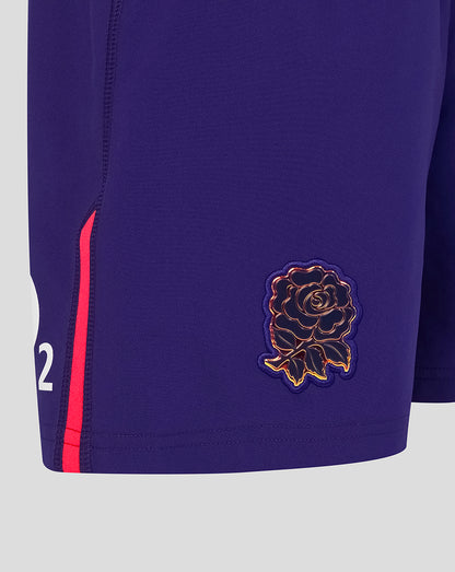 Navy shorts with a gold rose emblem and red stripe on a light gray background