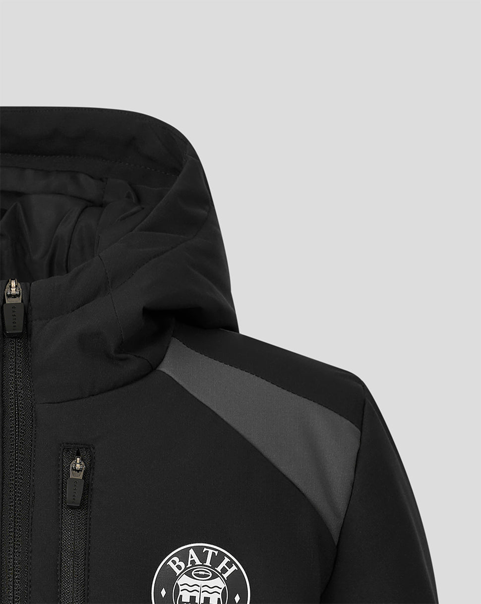 Close-up of a black hooded jacket with a gray shoulder panel and a white circular BATH logo on the chest, shown against a light gray background.