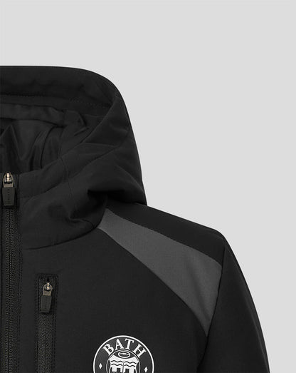 Close-up of a black hooded jacket with a gray shoulder panel and a white circular BATH logo on the chest, shown against a light gray background.