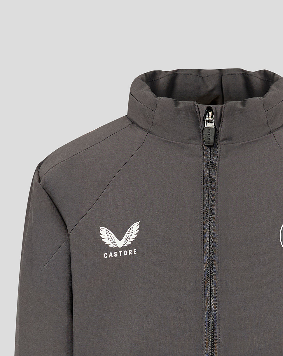 Close-up of a dark gray athletic jacket with a high collar, front zipper, and a white Castore wing logo on the chest, set against a solid light gray background.