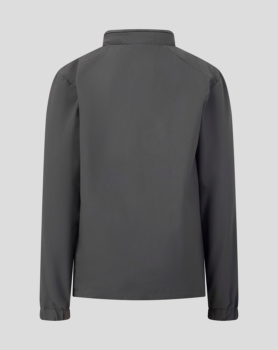 A dark gray long-sleeve jacket shown from the back, featuring a high collar and subtle shoulder seam details, set against a solid light gray background.