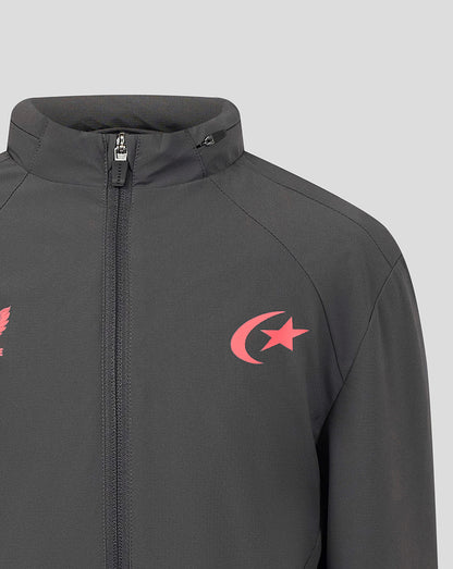 A close-up of a dark gray zip-up jacket featuring a red crescent and star logo on the left chest, set against a solid light gray background.