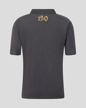 A dark gray short-sleeve polo shirt shown from the back, featuring a gold '150' graphic printed on the upper back, set against a solid light gray background.