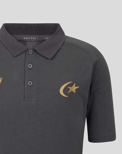 A close-up of a dark gray short-sleeve polo shirt with a gold embroidered crescent moon and star on the left chest, featuring a three-button placket and a dark gray ribbed collar.