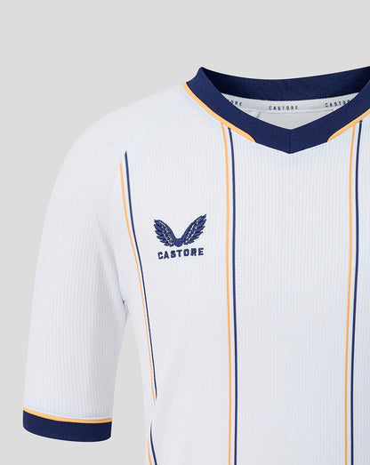 Close up of Everton junior away shirt chest showing crest and navy blue and gold piping on white fabric