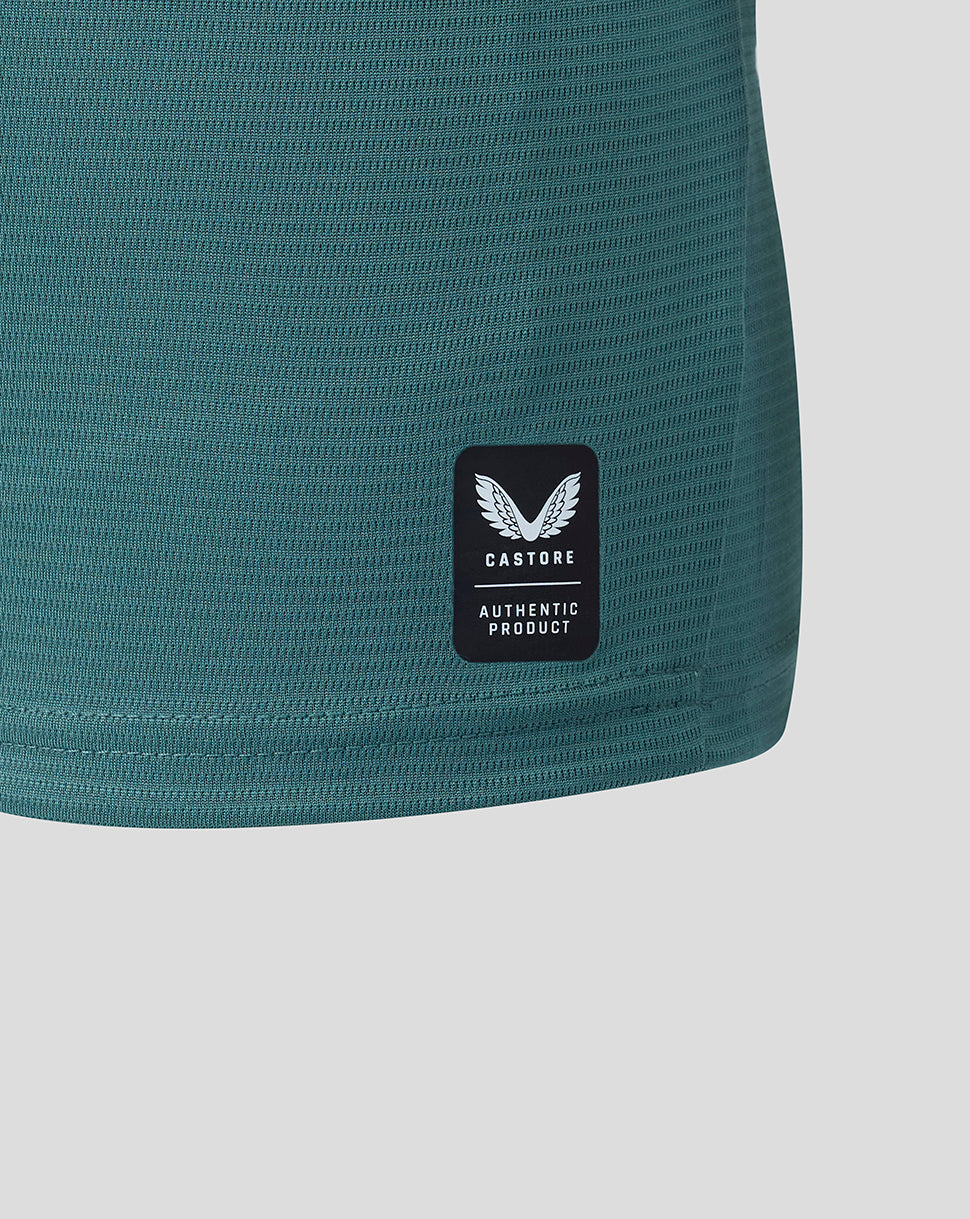 Close up of hem showing Castore authentic product patch on teal Everton shirt