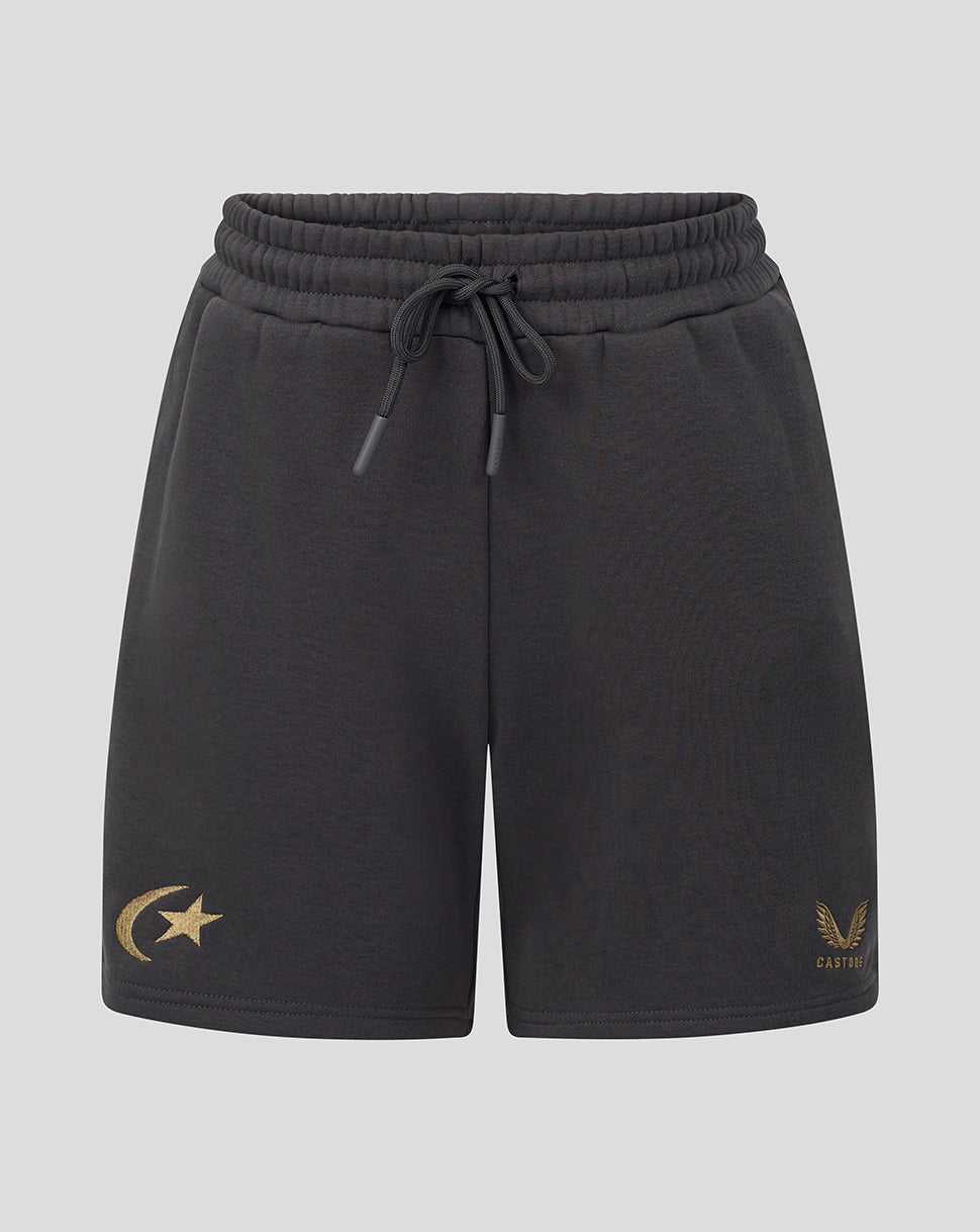 Black drawstring shorts with a gold crescent and star logo on the left leg and a gold winged emblem with 'castore' text on the right leg, shown against a light gray background.