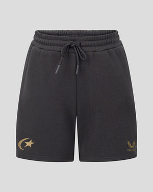 Black drawstring shorts with a gold crescent and star logo on the left leg and a gold winged emblem with 'castore' text on the right leg, shown against a light gray background.