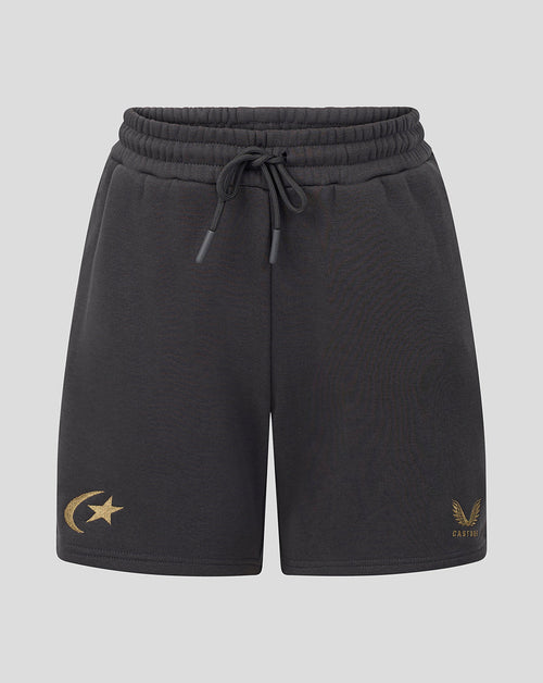 Black drawstring shorts with a gold crescent and star logo on the left leg and a gold winged emblem with 'castore' text on the right leg, shown against a light gray background.