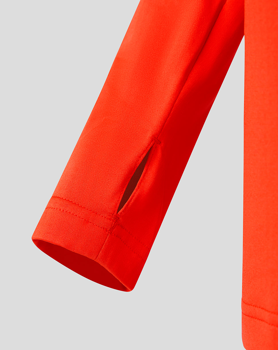 Bright orange Feyenoord junior midlayer sleeve with a vent slit and stitched cuff