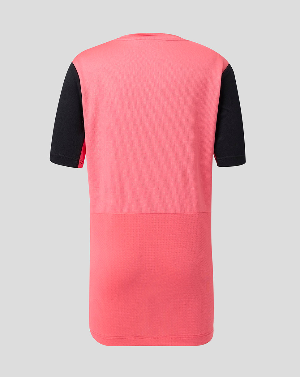 Pink and black short sleeve top on a gray background