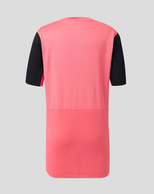 Pink and black short sleeve top on a gray background