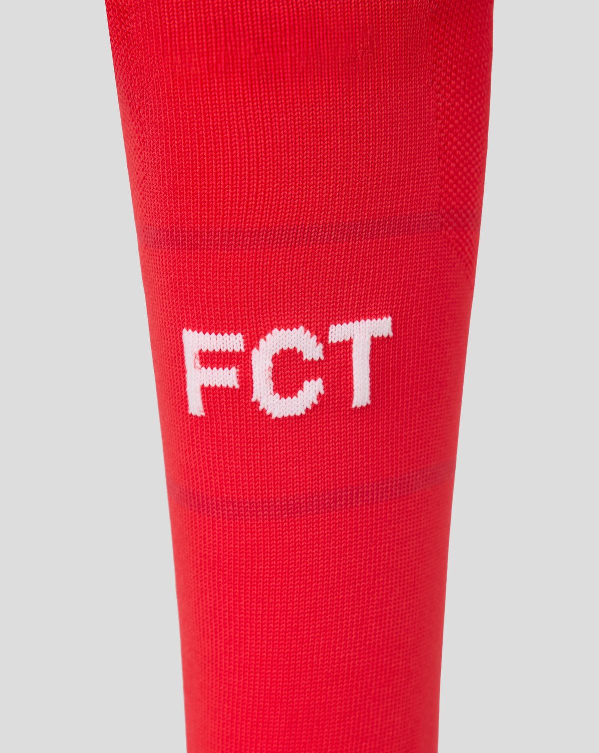 Close up of FC Twente Junior 26/27 home sock knit in red with white lettering