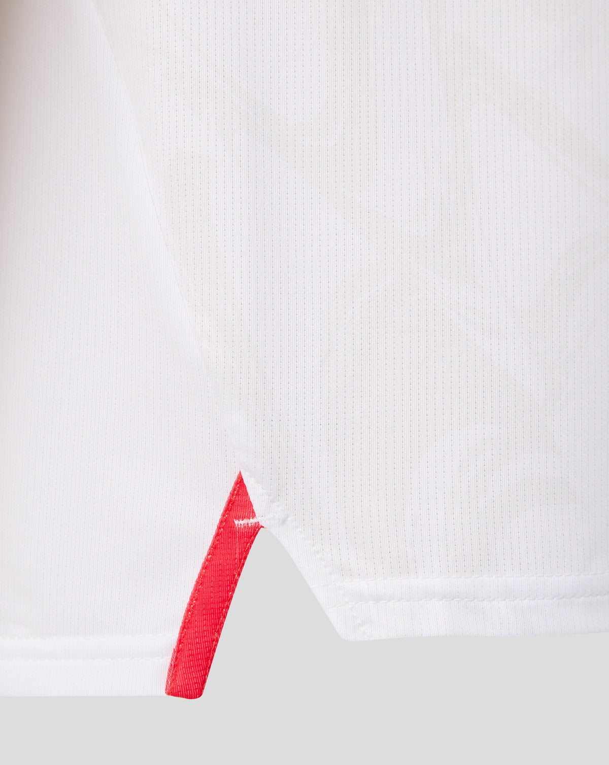 White FC Twente junior matchday shirt fabric close-up with a red diagonal stripe detail
