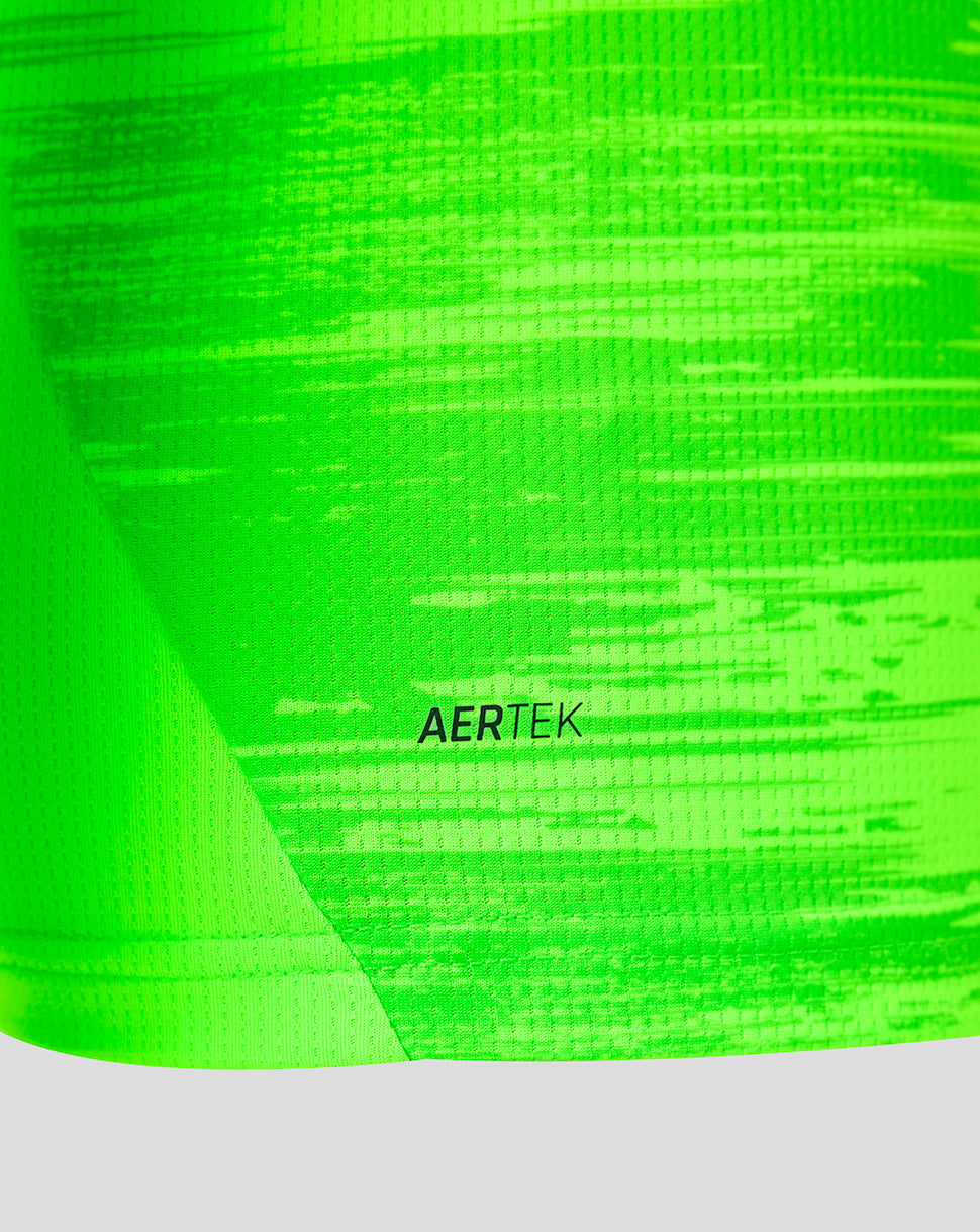 Close-up of neon green fabric with AERTEK branding on the goalkeeper shirt