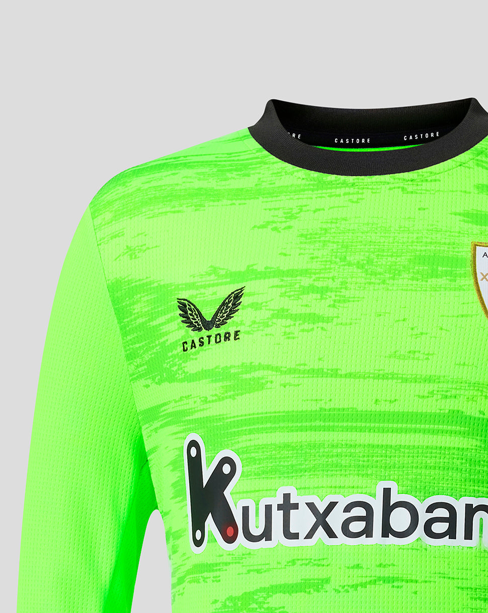 Close-up of neon green goalkeeper jersey showing Athletic Club crest on the chest and Kutxabank sponsor across the front.