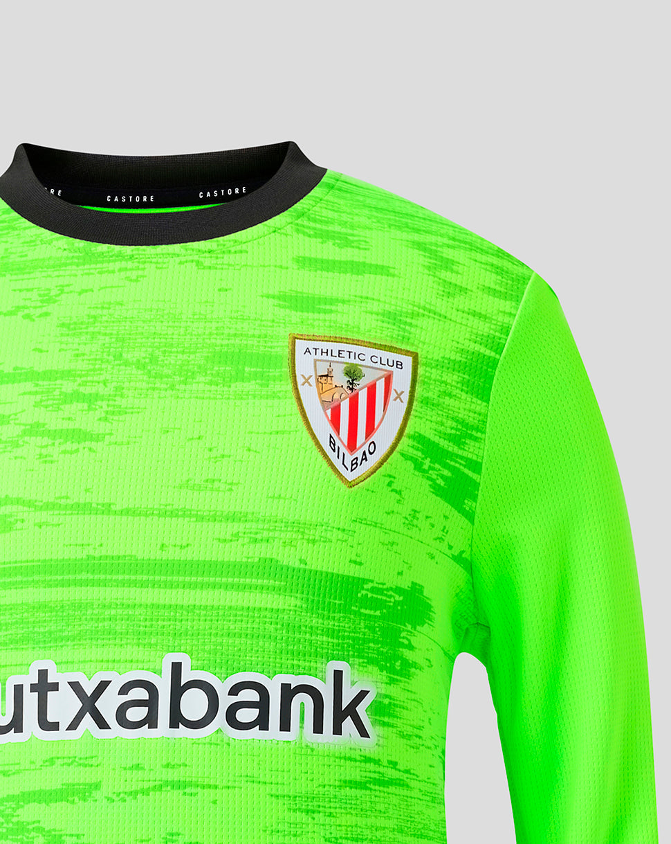 Close-up of neon green goalkeeper jersey featuring the Athletic Club crest on the chest and Kutxabank logo on the front.