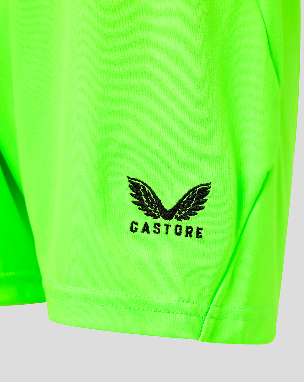 Close-up of neon green fabric showing the Castore logo near the hem of Athletic Club goalkeeper shorts.