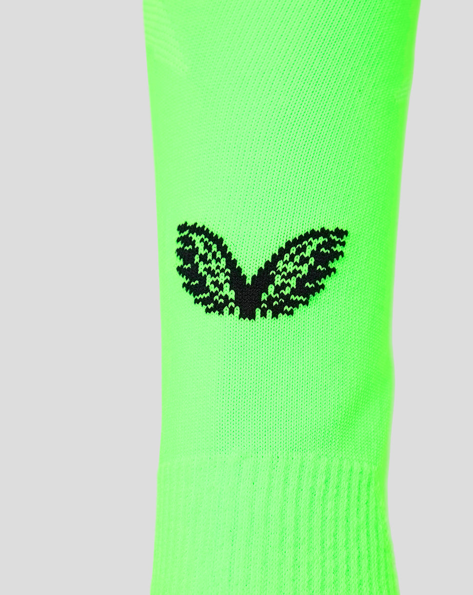 Neon green goalkeeper sock close-up featuring a black winged emblem on the calf.