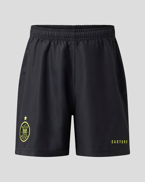 Black athletic shorts with a yellow Castore logo on the left leg and a yellow crest on the right leg, shown against a light gray background.